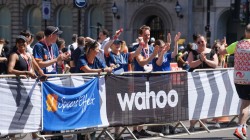 Special Effect team cheering the runners on from behind the barriers near the finishing line.